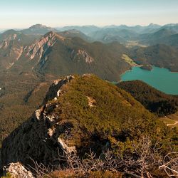 High angle view of lake and mountains against sky