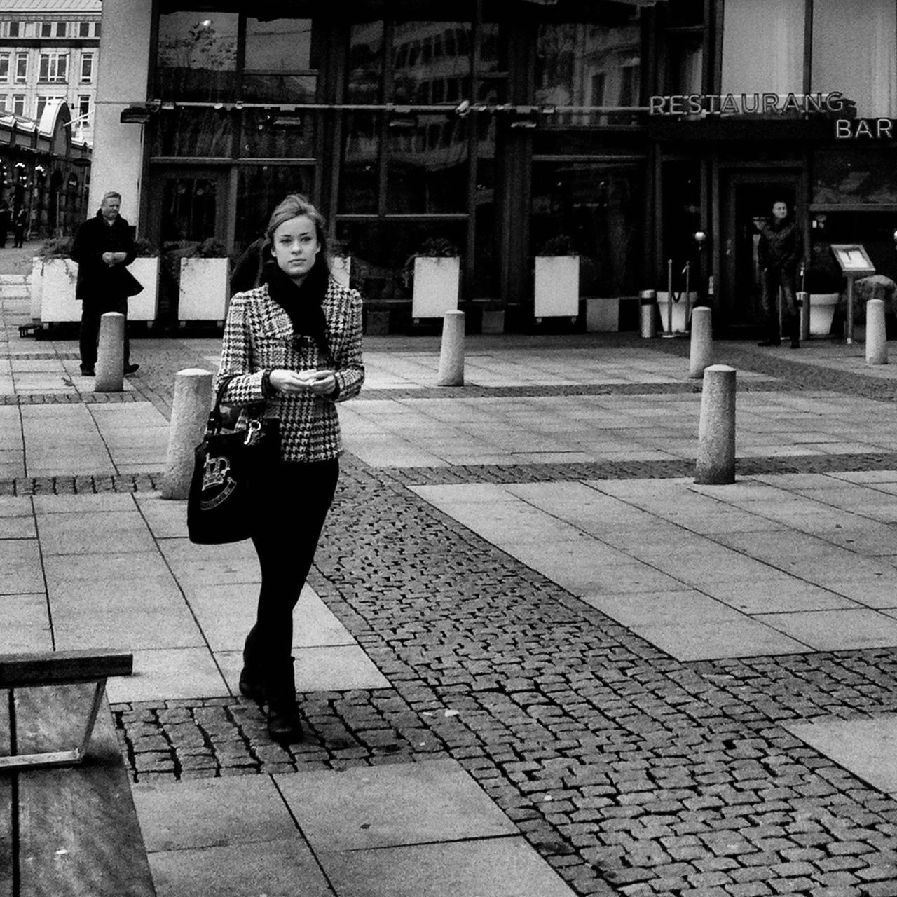 full length, lifestyles, casual clothing, building exterior, leisure activity, architecture, built structure, standing, person, young adult, front view, street, walking, young women, sidewalk, city, portrait, looking at camera