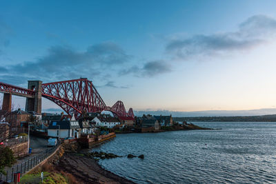 View of bridge over sea against cloudy sky