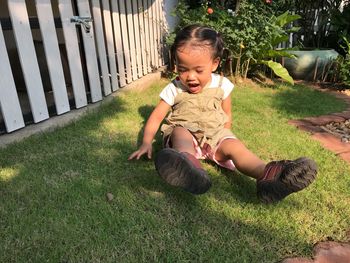 Cute girl playing in yard during sunny day