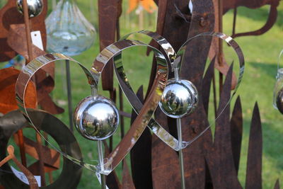 Close-up of lighting equipment hanging on metal fence