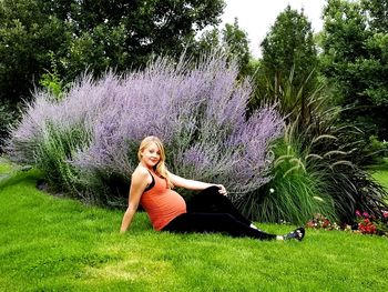 Portrait of woman sitting on purple tree