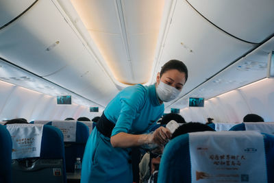 Rear view of man looking at airplane