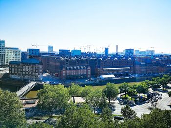 High angle view of city buildings against clear sky