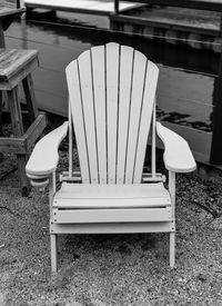 Empty chairs and table at beach