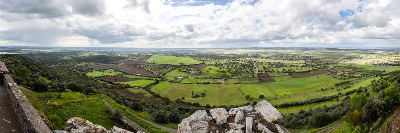 Panoramic view of agricultural field against sky