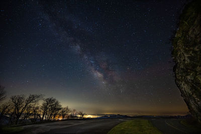 Scenic view of road against sky at night