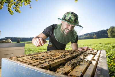 Man standing on agricultural field against clear sky