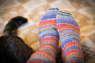 Low section of person relaxing on sofa at home