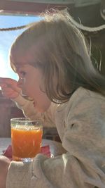 Close-up portrait of a girl drinking glass