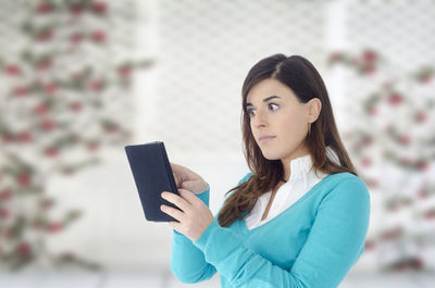 Shocked woman using digital tablet