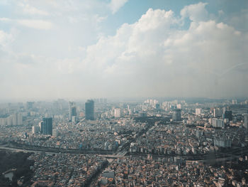 Aerial view of city buildings against sky