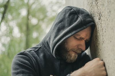 Man leaning on wall