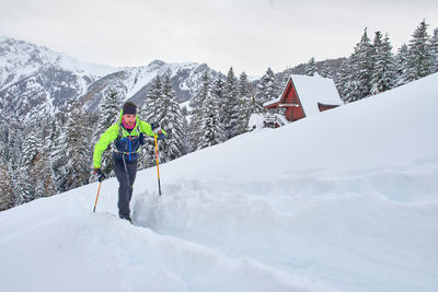 Rear view of man on snowcapped mountain