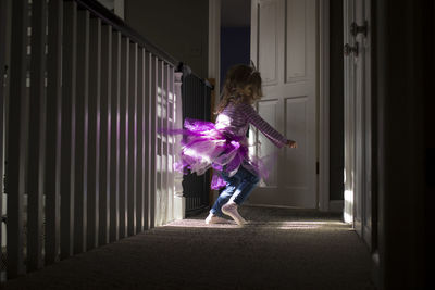 Happy girl wearing costume dancing at home