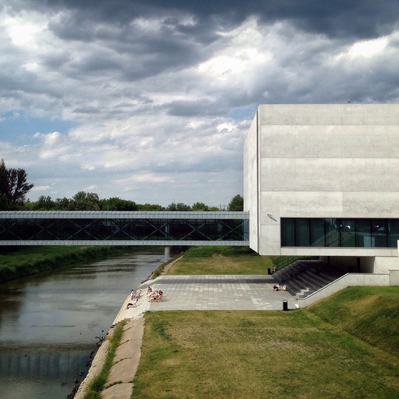 sky, cloud - sky, architecture, built structure, water, building exterior, cloudy, grass, river, cloud, transportation, tree, lake, day, nature, city, outdoors, overcast, mode of transport