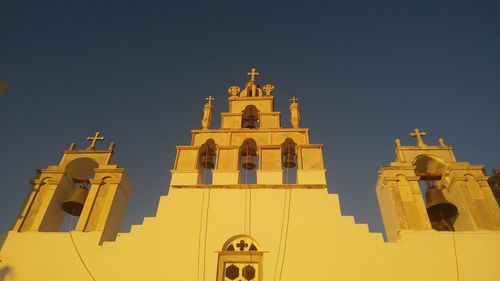 Low angle view of old church against clear sky during sunset