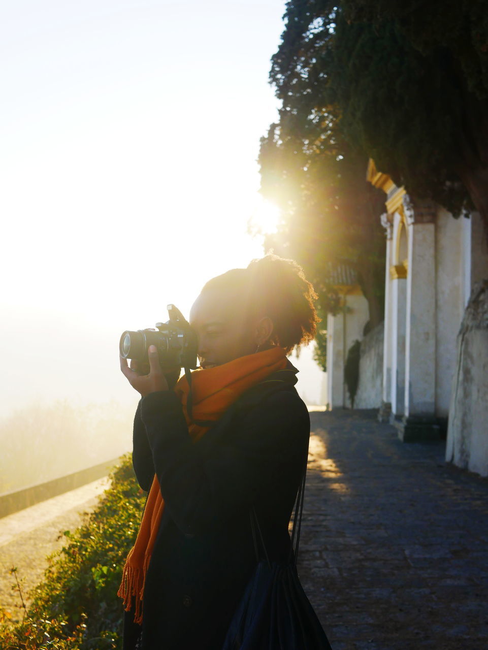 REAR VIEW OF MAN PHOTOGRAPHING