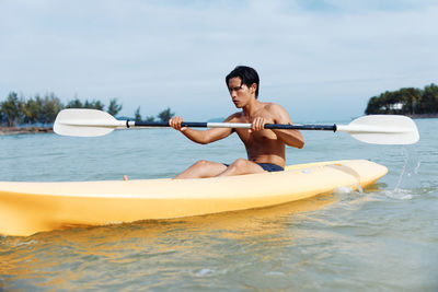 Man kayaking in lake