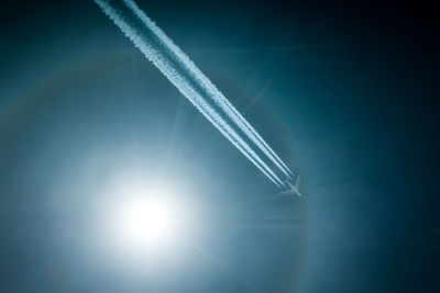 Low angle view of airplane flying against sky