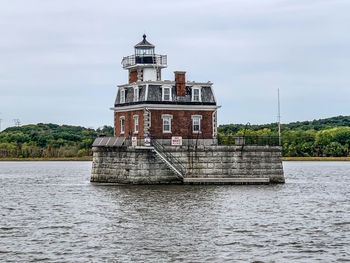 Scenic view of sea and lighthouse against sky