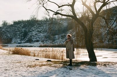 Rear view of woman walking on field