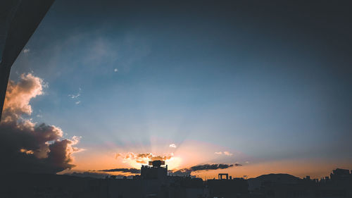 Silhouette buildings against sky during sunset