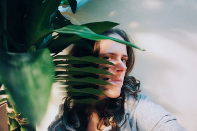 Portrait of a young woman with plant