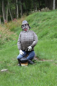 Fake dummy of man sitting in forest