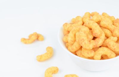 Close-up of cookies in bowl against white background
