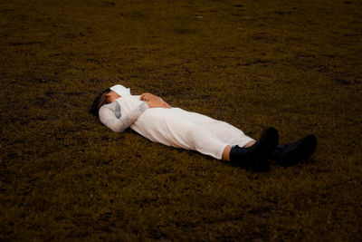 Low section of woman lying on field