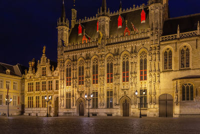 Gothic bruges town hall on burg square at evening, belgium