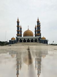 Reflection of mosque against sky.