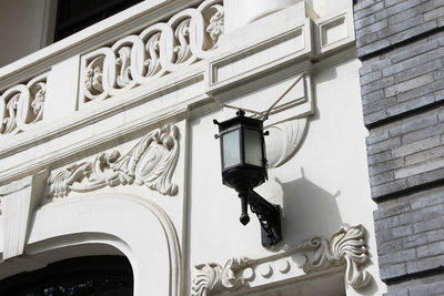 Low angle view of street light on building