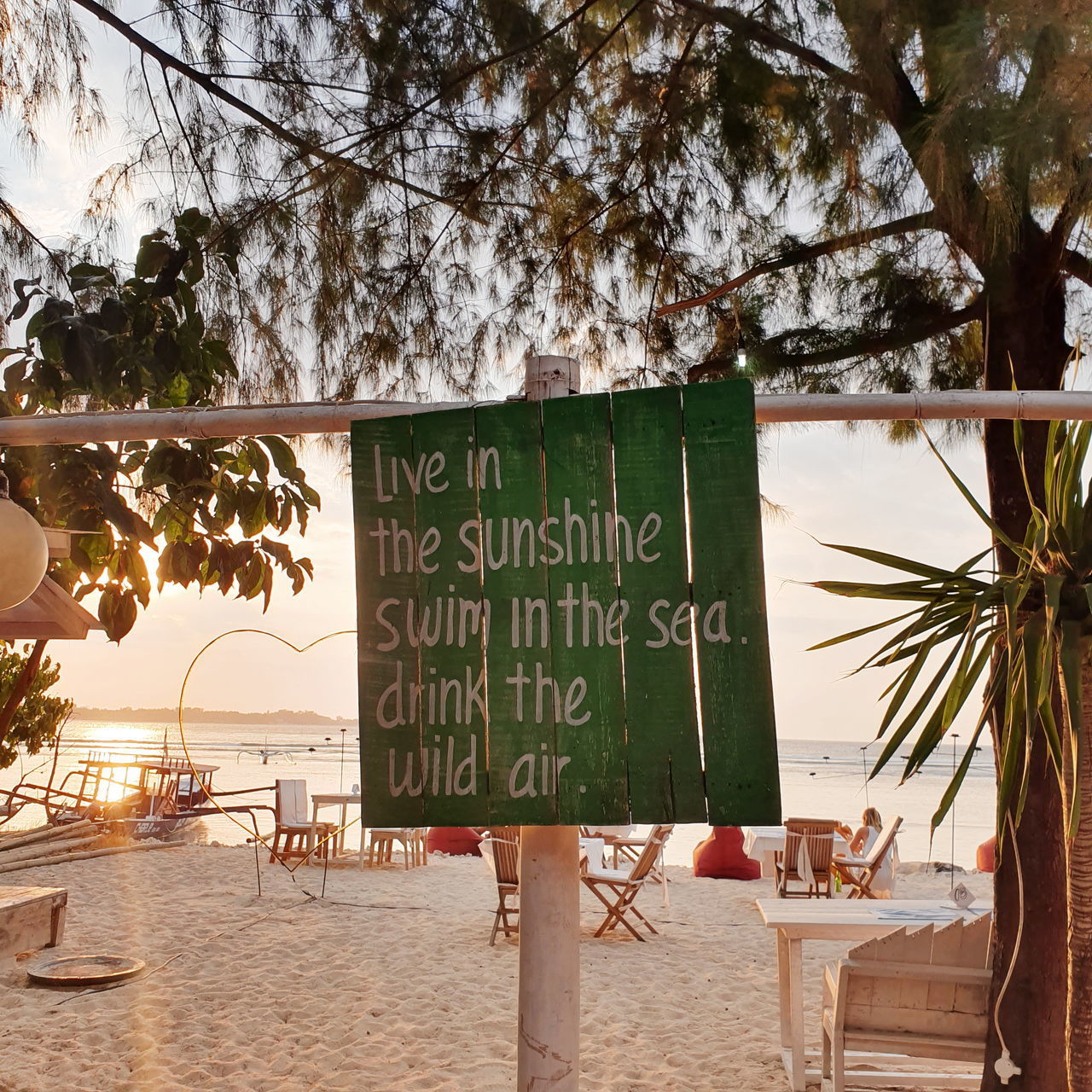 INFORMATION SIGN ON TABLE BY TREE