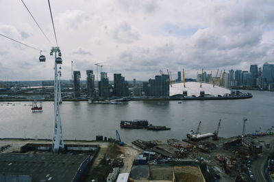 High angle view of river by buildings in city against sky