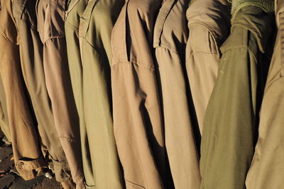 Close-up of jackets hanging side by side for sale