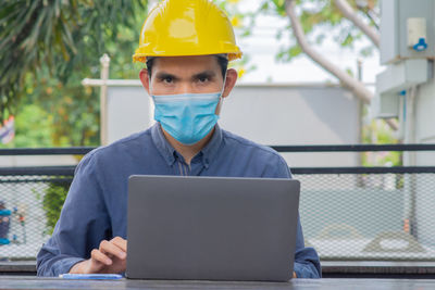 Portrait of man working with mobile phone