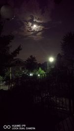 Silhouette of trees against sky at night