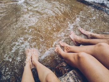 Low section of people with legs in water