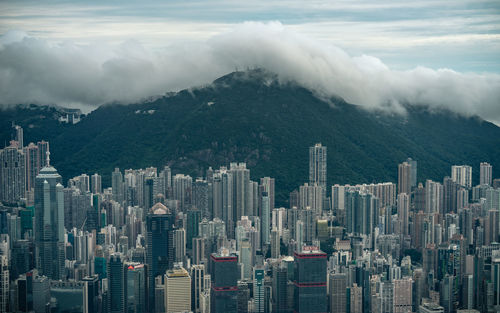 Aerial view of buildings in city against sky