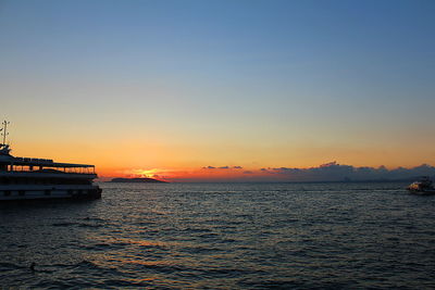 Scenic view of sea against clear sky during sunset