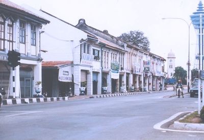 Empty road with buildings in background