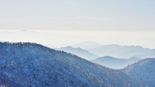 Scenic view of snowcapped mountains against sky