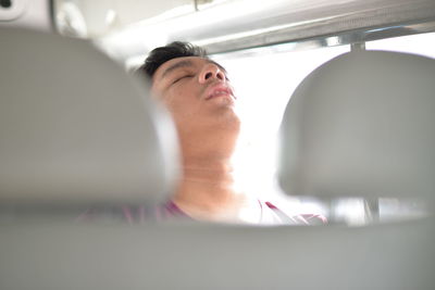 Tired man traveling in car