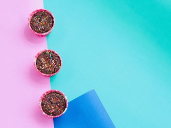 High angle view of candies on table against blue background