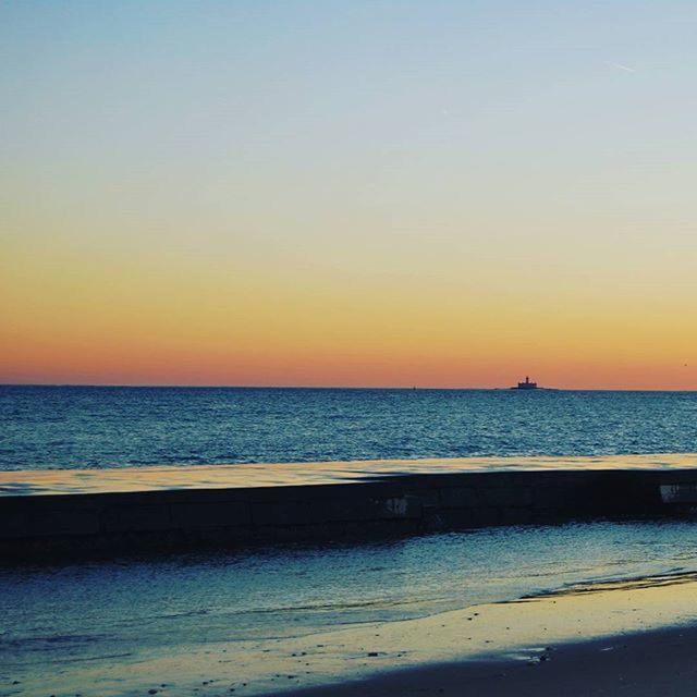 sea, water, horizon over water, sunset, scenics, transportation, nautical vessel, tranquil scene, beauty in nature, tranquility, clear sky, boat, copy space, nature, mode of transport, orange color, sky, beach, idyllic, outdoors