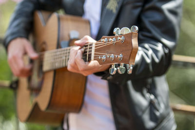 Hands of man playing guitar