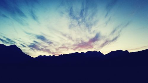 Scenic view of mountains against cloudy sky