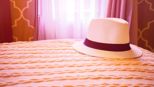 Close-up of hat on bed at home